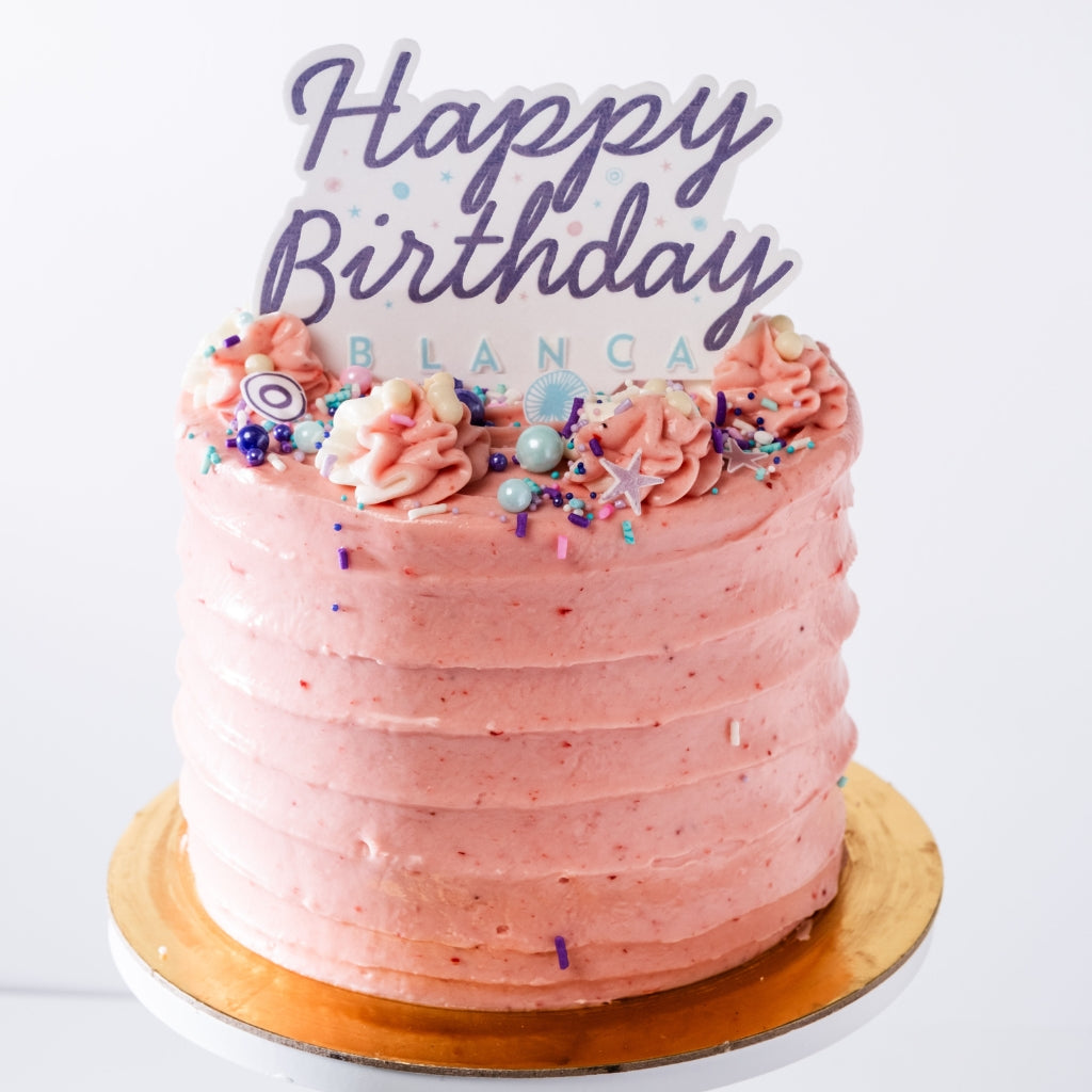 6-inch strawberry cake with pink cream cheese frosting, colorful sprinkles, and a Happy Birthday Blanca cake topper.