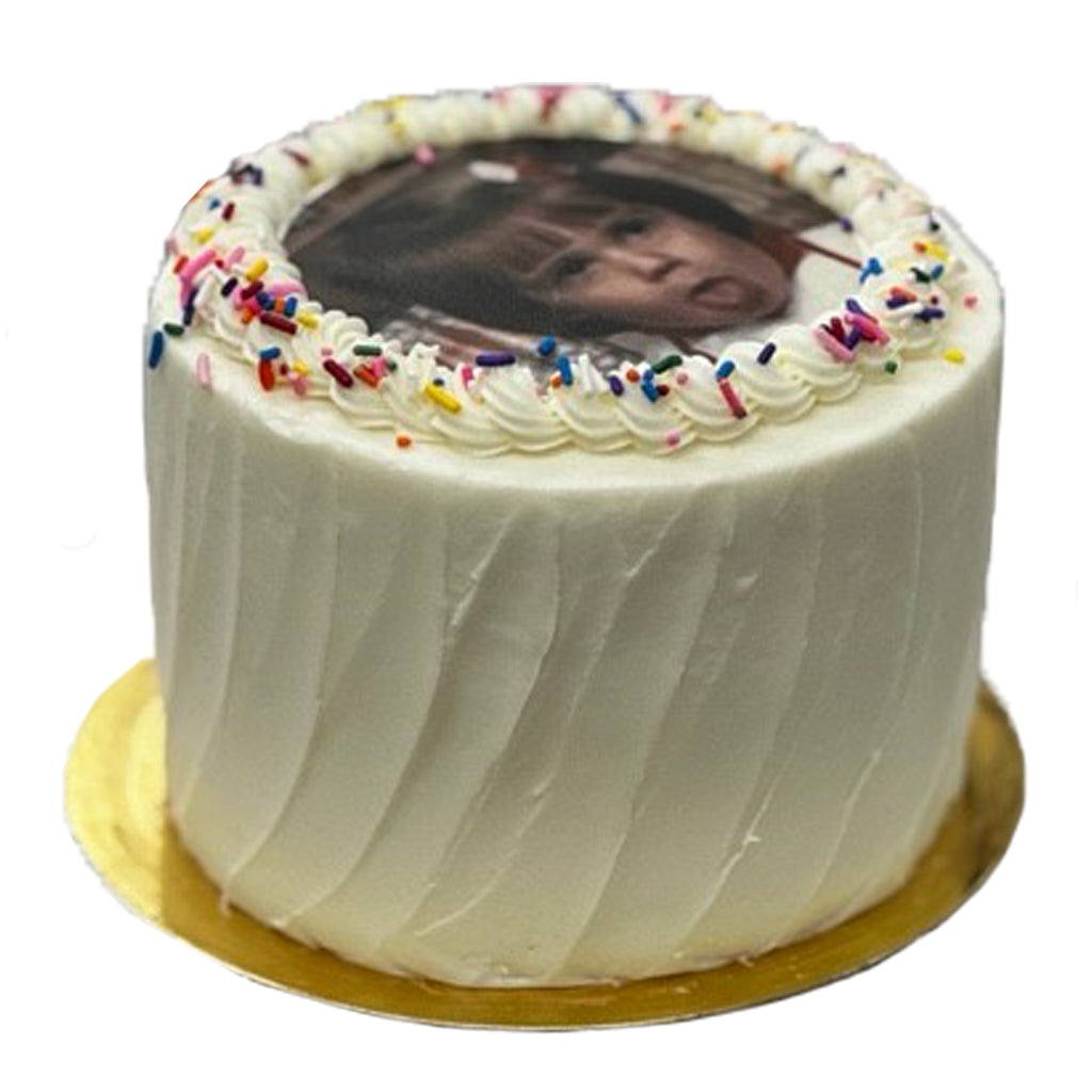 6-inch round cake with white swirled frosting, rainbow sprinkles, and a custom printed photo on top.